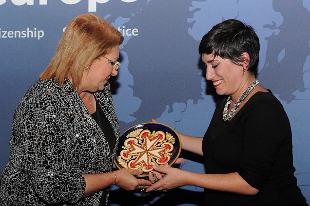 Carla (Legal Officer) accepting the away from the President of Malta.